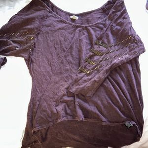 Purple shirt with design on sleeve